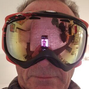 Oakley Orange Yellow and Black Snow Goggles with Yellow-tinted Reflective Lens.